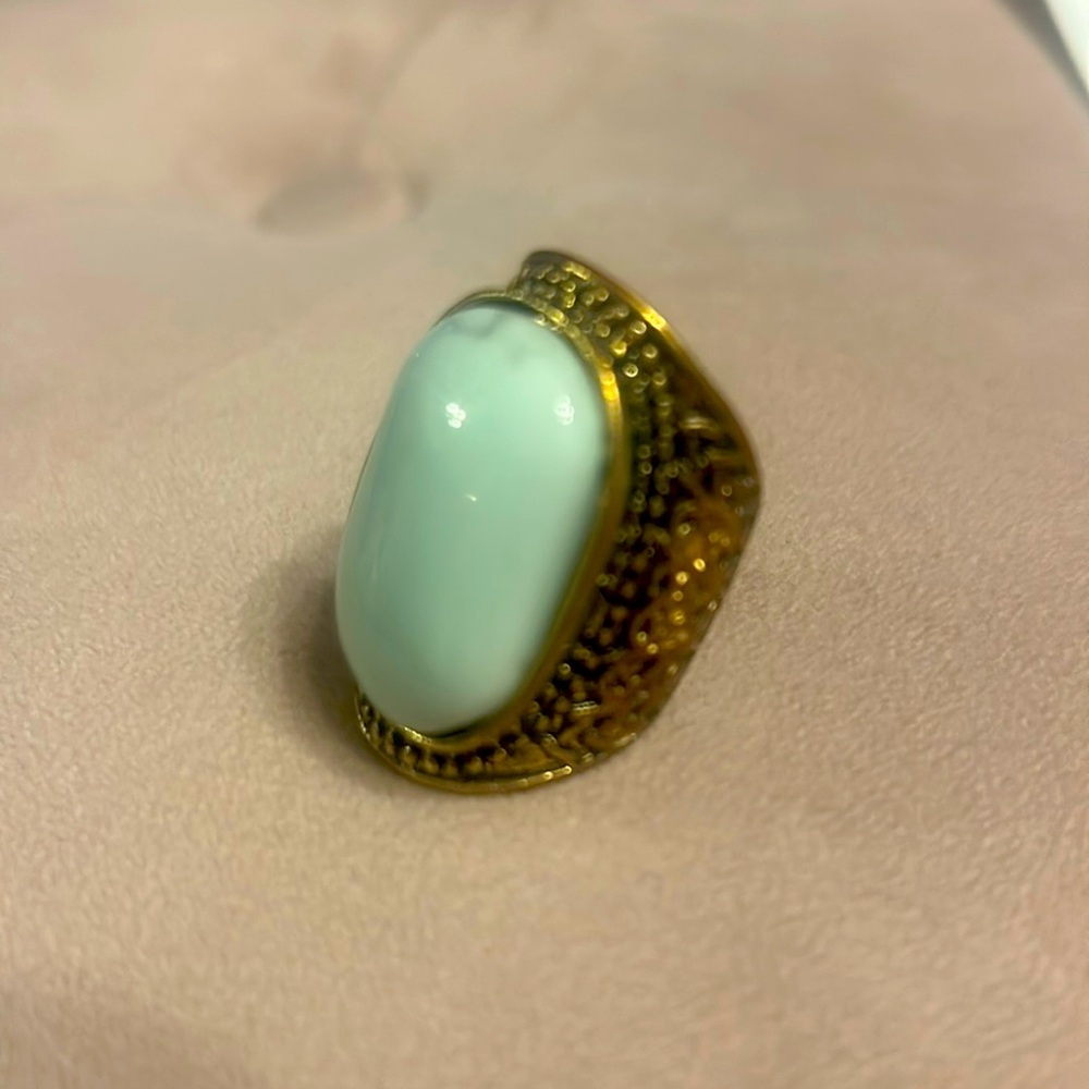 Large teal stone ring with dark gold trim